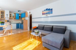 a living room with a couch and a table at Apartment Kristian in Cres