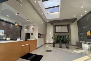 a large lobby with a reception desk and a window at Travelodge Inn & Suites by Wyndham Anaheim on Disneyland Dr in Anaheim