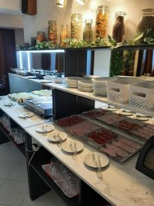 a buffet line with plates of food in a restaurant at Pensiunea Constanta in Predeal