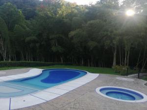 a swimming pool in the middle of a yard at Habitación en casa Rural Campestre in La Vega