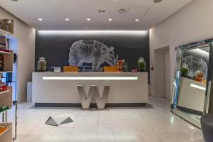 a store with a w sign on the wall at Hotel White in Rome