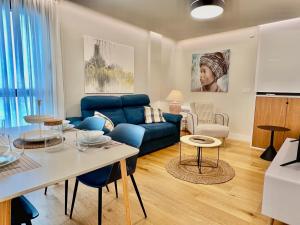 sala de estar con sofá azul y mesa en PUENTE SANTIAGO APOSTOL en Pontevedra