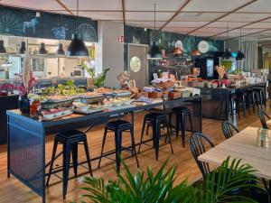 a restaurant with a buffet of food on a table at Scandic Växjö in Växjö