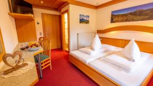 ein Hotelzimmer mit einem Bett und einem Tisch in der Unterkunft Berggasthof Lahnerhof in Liesing