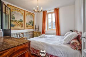 a bedroom with a white bed and a window at Villa Del Arte — Family house, sea view & parking in Villerville