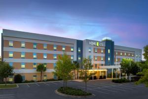 a large building with a parking lot in front of it at Home2 Suites by Hilton Tallahassee State Capitol in Tallahassee