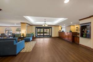 a lobby of a hospital with blue chairs and tables at Comfort Inn Fayetteville I-95 in Fayetteville