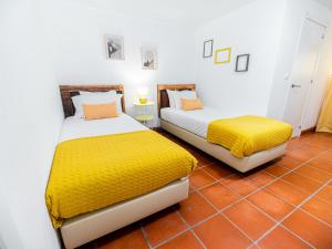 two beds sitting next to each other in a room at VILA NATURA in Barreiro