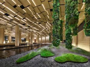 a lobby with plants on the floor of a building at Hilton Nanjing Niushoushan in Nanjing