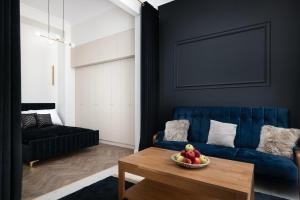 a living room with a blue couch and a bowl of fruit on a table at EASY RENT- ART DECO PREMIUM Spokojna 10, Centrum, 24h Check-in in Lublin +28 photos