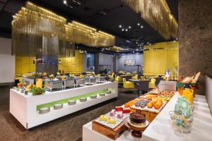 a restaurant with a buffet of food on display at Aloft Bengaluru Outer Ring Road in Bangalore
