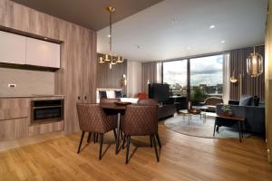 a living room with a table and a dining room at Salvio Parque 93 Bogota, Curio Collection by Hilton in Bogotá