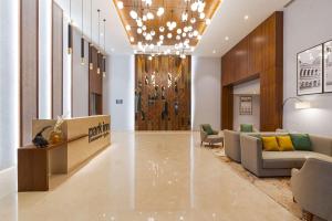 a lobby of a hotel with a couch and chairs at Park Inn by Radisson Ayodhya in Ayodhya