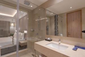 a large bathroom with a sink and a shower at Park Inn by Radisson Ayodhya in Ayodhya