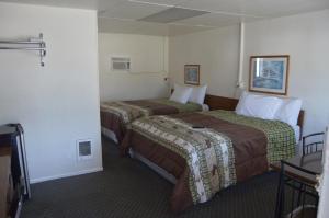 A bed or beds in a room at Newport Antler Motel
