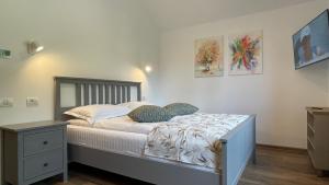 a bedroom with a bed and a nightstand and a bed sidx sidx sidx sidx at PENTA Apartments in Sinaia