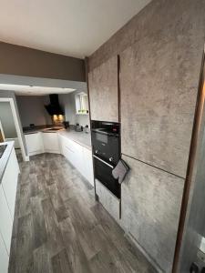 a kitchen with a refrigerator and a counter top at Luxurious 2 Bedroom Private Detached Cottage in Llanddulas