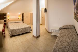 ein Hotelzimmer mit zwei Betten, einem Tisch und einem Zimmer in der Unterkunft Hotel Lady G in Tortoreto Lido + 110 Fotos