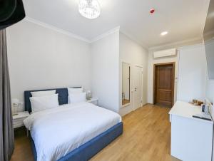 Postel nebo postele na pokoji v ubytování Kyiv Honchara Hotel