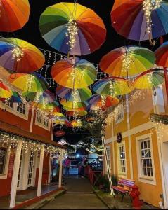 a bunch of colorful umbrellas hanging from a building at POUSADA ESTÂNCIA in Penedo