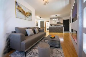 a living room with a couch and a table at Apartment Queen - private parking in Osijek