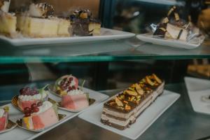 a display case with different types of cakes and desserts at Coop Hotell in Jõgeva