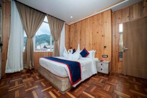 a bedroom with a large bed with a large window at Zip By Spree Hotels Gangtok in Gangtok