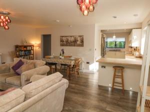 a living room with a couch and a table at Causeway Hideaway in Sheffield