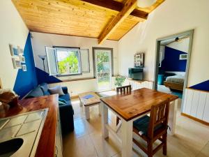 ein Wohnzimmer mit einem Tisch und einem Sofa in der Unterkunft Sea Roots "Garden Zone " in Mosteiros