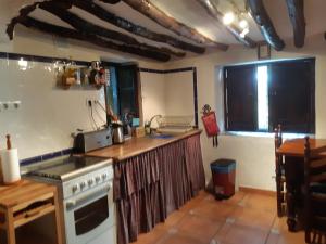 a kitchen with a stove and a counter top at Casita Tomate in Granada