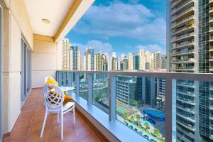 a balcony with a chair and a view of a city at Luxury 1 Bedroom Marina View, Sleeps 6, 1 Min to Metro in Dubai