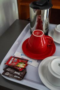 a tray with a red tea pot on a table at Villa Doria formerly Rangga Homestay in Gili Islands