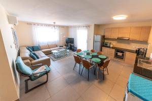 a living room with a couch and a table with chairs at 3 bed, Kapparis, Thea - 3A in Paralimni