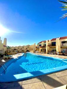 a large swimming pool in front of a building at Mariposa Azul in Adeje