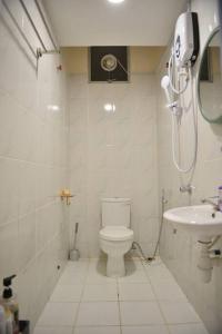 a small bathroom with a toilet and a sink at Your home away from home. in Sandakan