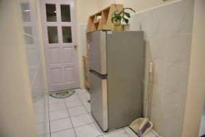 a kitchen with a stainless steel refrigerator in a room at Your home away from home. in Sandakan