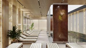 a waiting room with lounge chairs and a pool at Elite World Kuşadası in Kuşadası