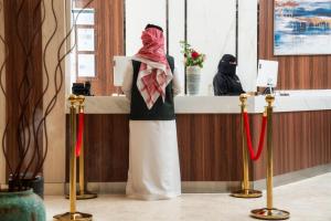 a woman is standing at a counter in a salon at القصر الكورنيش in Jazan