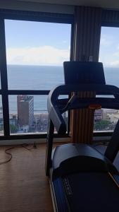 un gimnasio con vistas al océano desde una ventana en Barra Caravela Studio, en Salvador