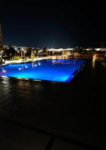 a large swimming pool lit up at night at Scandic Resort Apartment B 608 Hurghada in Hurghada