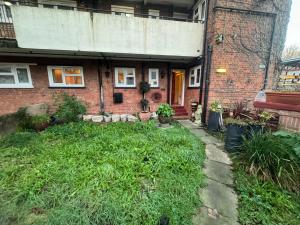 an old brick house with a grass yard in front of it at Highgate Hill Room! in London