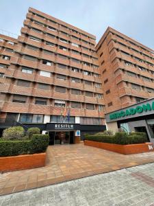 two tall buildings with bushes in front of them at Resitur Luxury Apartment 113 in Seville