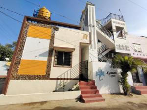 a house with a yellow door on the side of it at HEAVEN HOMESTAY in New Hampi