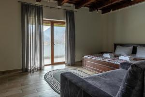 um quarto com uma cama, um sofá e uma janela em Шаян Гора em Shayan