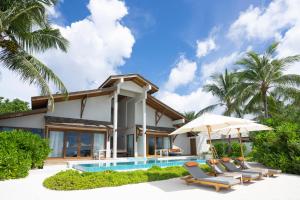 a villa with a swimming pool and a resort at Emerald Faarufushi Resort & Spa - Deluxe All Inclusive in Raa Atoll