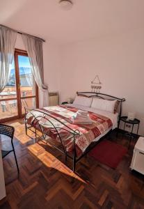 a bedroom with a bed and a large window at Gran Sasso Letizia BB in Filetto