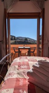 a room with a bed with a view of the desert at Gran Sasso Letizia BB in Filetto