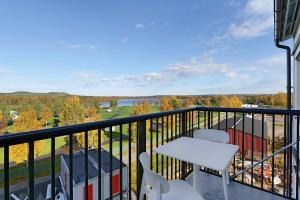 a balcony with a table and chairs and a view at Guestly Homes - 1BR Corporate Comfort in Boden