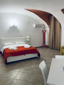 a bedroom with a bed with a red blanket at Napoli Apartment in Naples