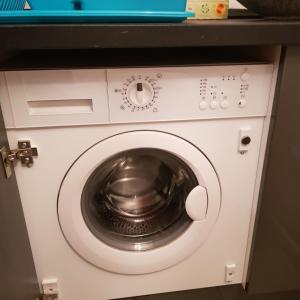 a washer and dryer in a room at Affection Apartment in Bologna